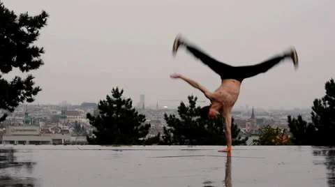 Breakdancer dancing breakdance in the rain in Prague Stock Footage 38334852