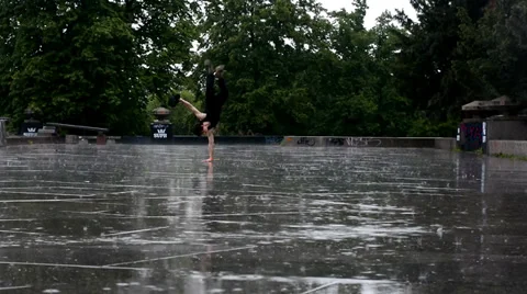 Breakdancer dancing breakdance in the rain in Prague Stock Footage 38334885