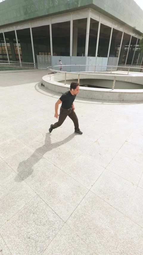Breakdancer performing acrobatics outdoors in urban environment Stock Footage 305910880