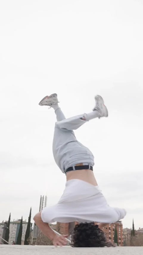 Breakdancer performing acrobatics on rooftop Stock Footage 305498346