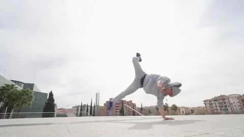 Breakdancer performing acrobatics in urban environment Stock Footage 308916837