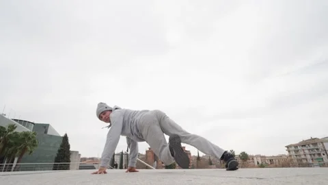 Breakdancer performing freeze and power moves outdoors Stock Footage 308916726