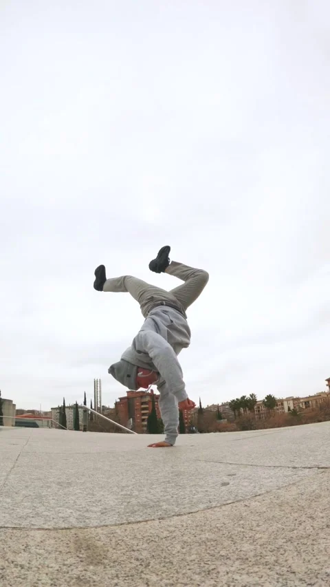 Breakdancer performing handstand freeze in urban environment Stock Footage 305497885