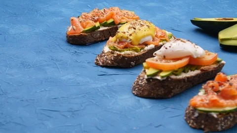 Breakfast and Snack Concept. Bruschettas on a blue table Stock Footage 122235885
