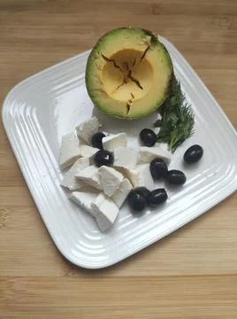 Breakfast with avocado, cheese and olives on a plate. Foto stock