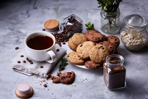 Breakfast background with mug of fresh coffee, homemade oatmeal cookies, grind Stock Photos