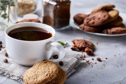 Breakfast background with mug of fresh coffee, homemade oatmeal cookies, grind Stock Photos
