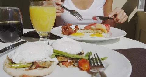 Breakfast with bacon and eggs at restaurant outside with orange juice Stock Footage 114630770