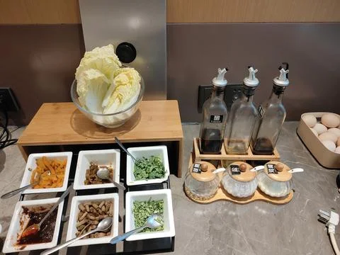 The breakfast bar features various vegetables, arranged in small white boxe.. Stock Photos