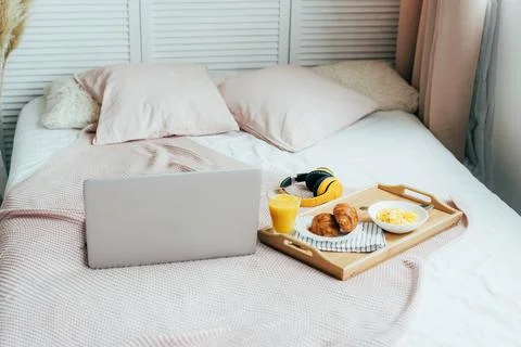 Breakfast on bed and laptop Stock Photos