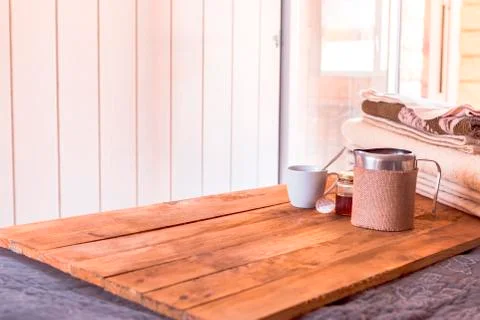 Breakfast in bed with blankets and cup on a wood. Photos
