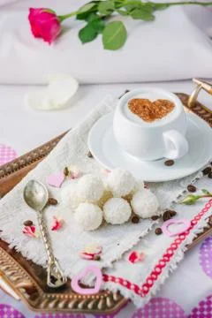 Breakfast in bed on copper tray over bed linens. Stock Photos