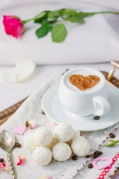 Breakfast in bed on copper tray over bed linens. Stock Photos
