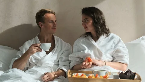 Breakfast in bed, couple sits and eats Stock Footage 122076882
