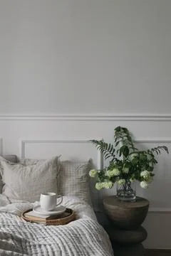 Breakfast in bed. Cup of coffee, wicker tray. Bouquet of white viburnum, fern Fotos Stock