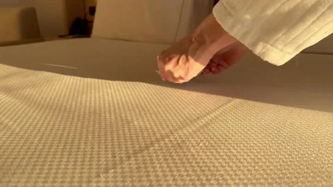 Breakfast in bed, female hands put cup of coffee on bed in sunlight Vídeo Stock 231752527