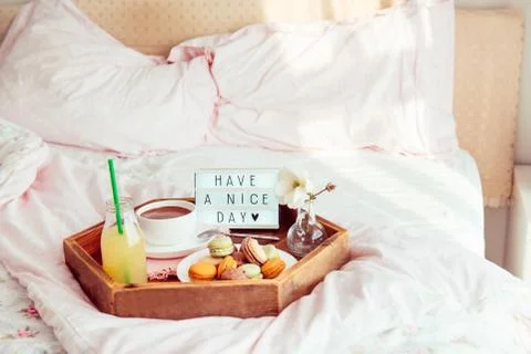 Breakfast in bed with Have a nice day text on lighted box. Cup of coffee, jui Stock Photos