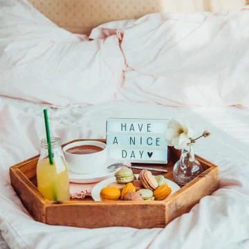 Breakfast in bed with Have a nice day text on lighted box. Cup of coffee, jui Stock Photos