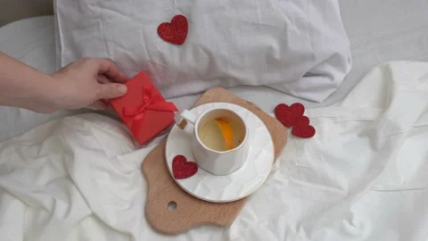 Breakfast in bed with hearts, hand puts a gift . Valentine's day Stock Footage 168396748