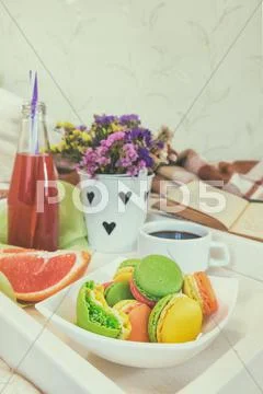 Breakfast in bed with hot coffee and macaroons Stock Photos