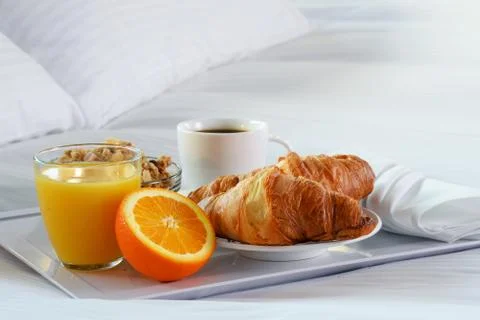 Breakfast in bed in hotel room. Accommodation. Stock Photos