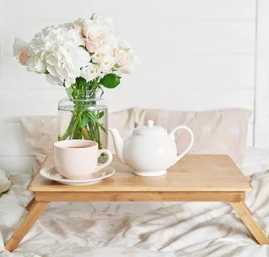 Breakfast in bed in hotel room. Accommodation. Breakfast in bed with tea cup  Stock Photos
