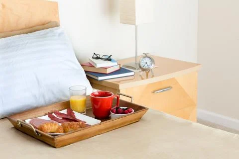 Breakfast in Bed Tray on Bed Next to Bedside Table Stock Photos