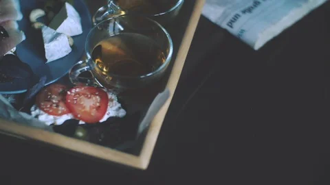 Breakfast in bed, tray with belgian waffles with blueberry and cup of lemon tea Stock Footage 85709284