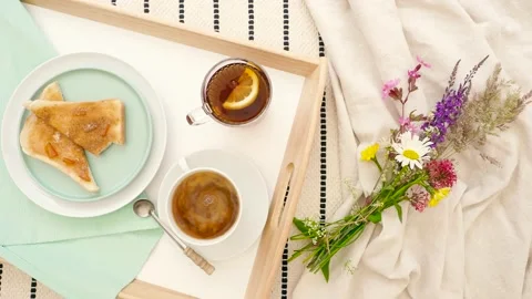 Breakfast in Bed. Tray with tea, toast, and flowers Stock-Footage 156451578