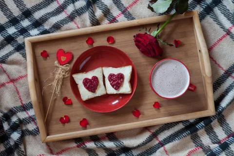 Breakfast in bed for Valentines Day. Romantic present with rose flower, toasts Stock Photos