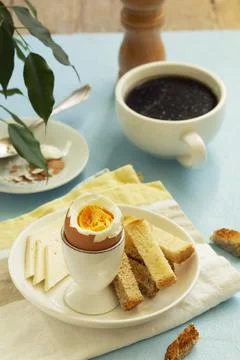 Breakfast with boiled eggs, cheese, bread toast and coffee. Rustic style. 스톡 사진