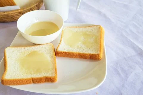 Breakfast, bread and milk on the table Stock Photos