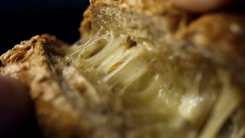 Breakfast bread with cheese on the kitchen table Video stock 104972972