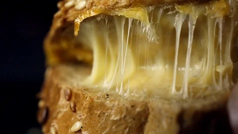 Breakfast bread with cheese on the kitchen table Video stock 104973000