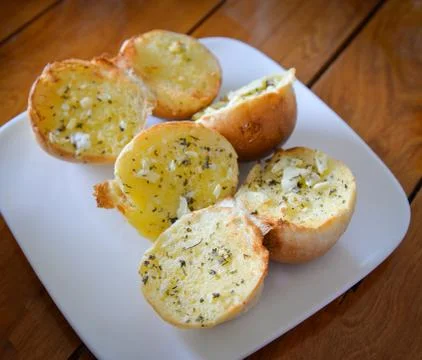 Breakfast bread on table / food or snack baked bread round cut half with spic Stock Photos