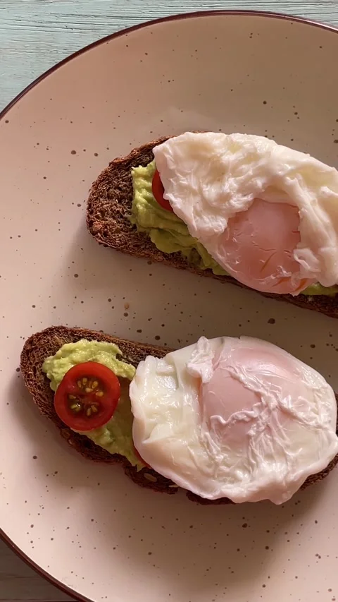 Breakfast of breads with silver cream cherry tomatoes and poached eggs. Stock Footage 287860544