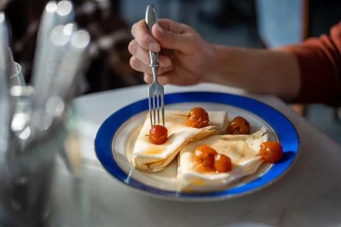 Breakfast, brunch, snack in cafe with hot baked golden crepes with sweet crab Stock Photos