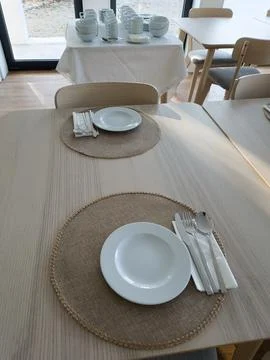 Breakfast buffet table set with clean tableware ready to use Stock Photos