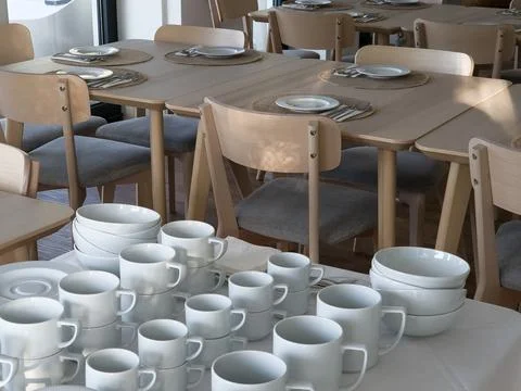 Breakfast buffet table set with clean tableware ready to use Stock Photos