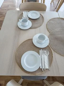 Breakfast buffet table set with clean tableware ready to use Stock Photos