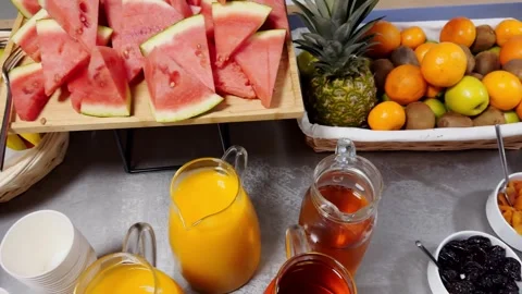 Breakfast buffet with watermelon slices, orange juice, ice tea and fresh Stock Footage 337736460