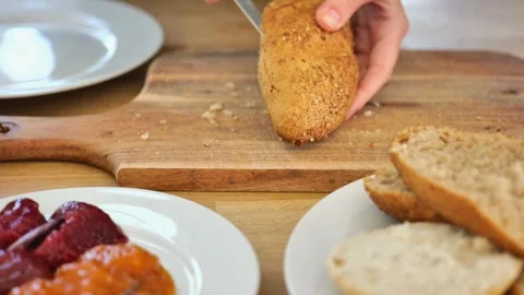 Breakfast buns.baking for breakfast.Hands cutting buns with a knife Stock Footage 263034634