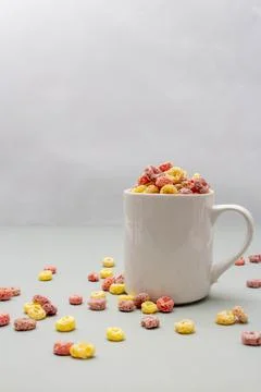 Breakfast cereal concept, Colorful ring cereals in coffee cup and falling on  Stock Photos