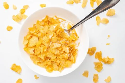 Breakfast cereal concept, Cornflakes and milk with spoon in bowl and cornflak Photos