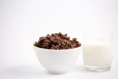 Breakfast cereal, cornflake chocolate in cups and milk is a healthy breakfast Stock Photos