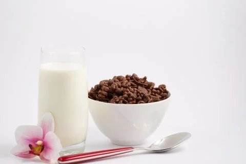 Breakfast cereal, cornflake chocolate in cups and milk is a healthy breakfast Stock Photos
