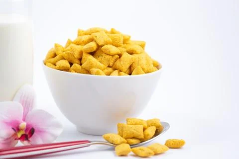 Breakfast cereal, cornflake, chocolate in cups and milk is a healthy breakfas Stock Photos