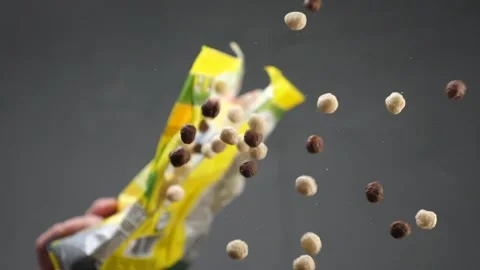 Breakfast with cereal falls on the plate Stock Footage 131849255