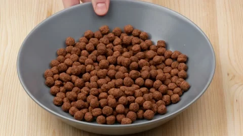 Breakfast cereal on the table. Chocolate balls in the bowl. Stock Footage 165557518