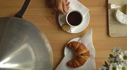 Breakfast with coffee, croissant and a smart watch. Top view. Dolly shot. Stock Footage